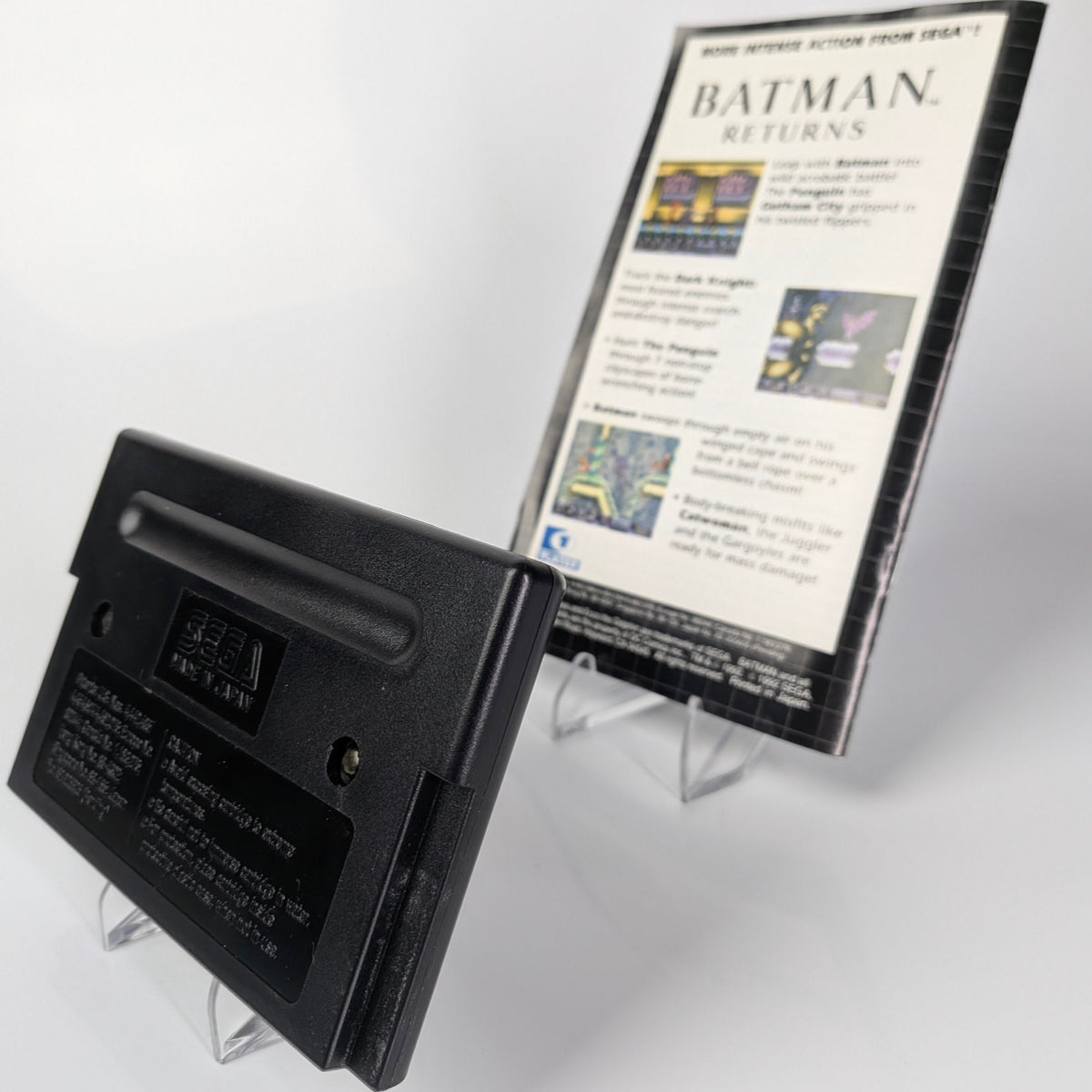 Black cartridge with a display stand featuring 'Batman Returns' text and graphics on a white background