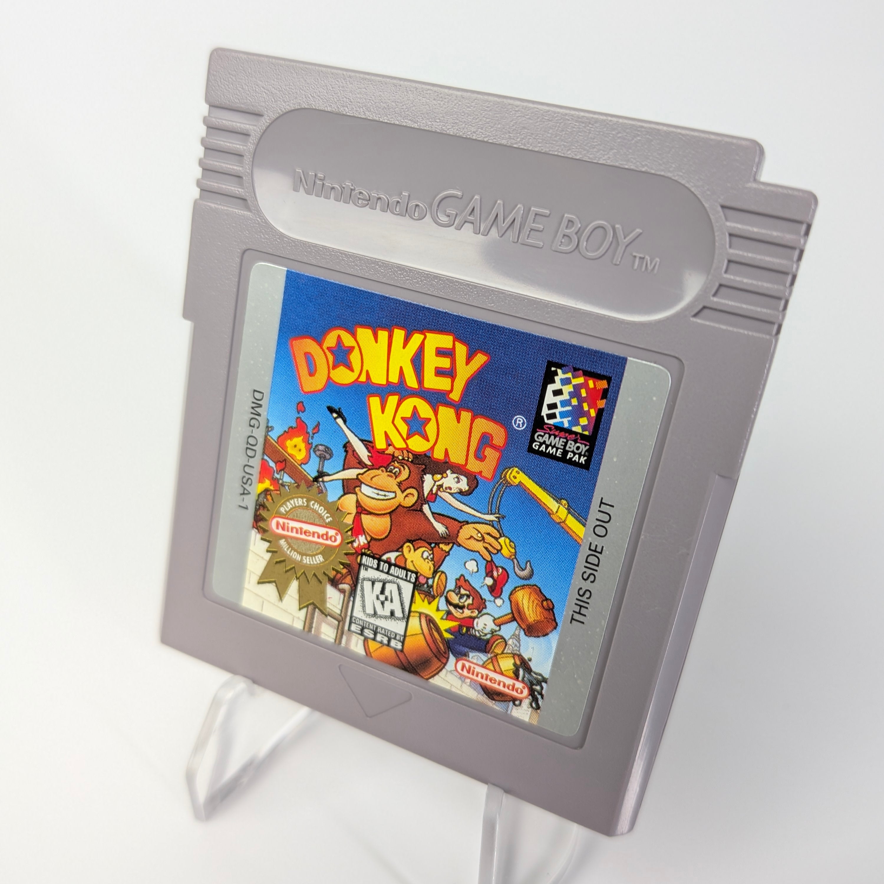 Nintendo Game Boy with a Donkey Kong cartridge on a white background