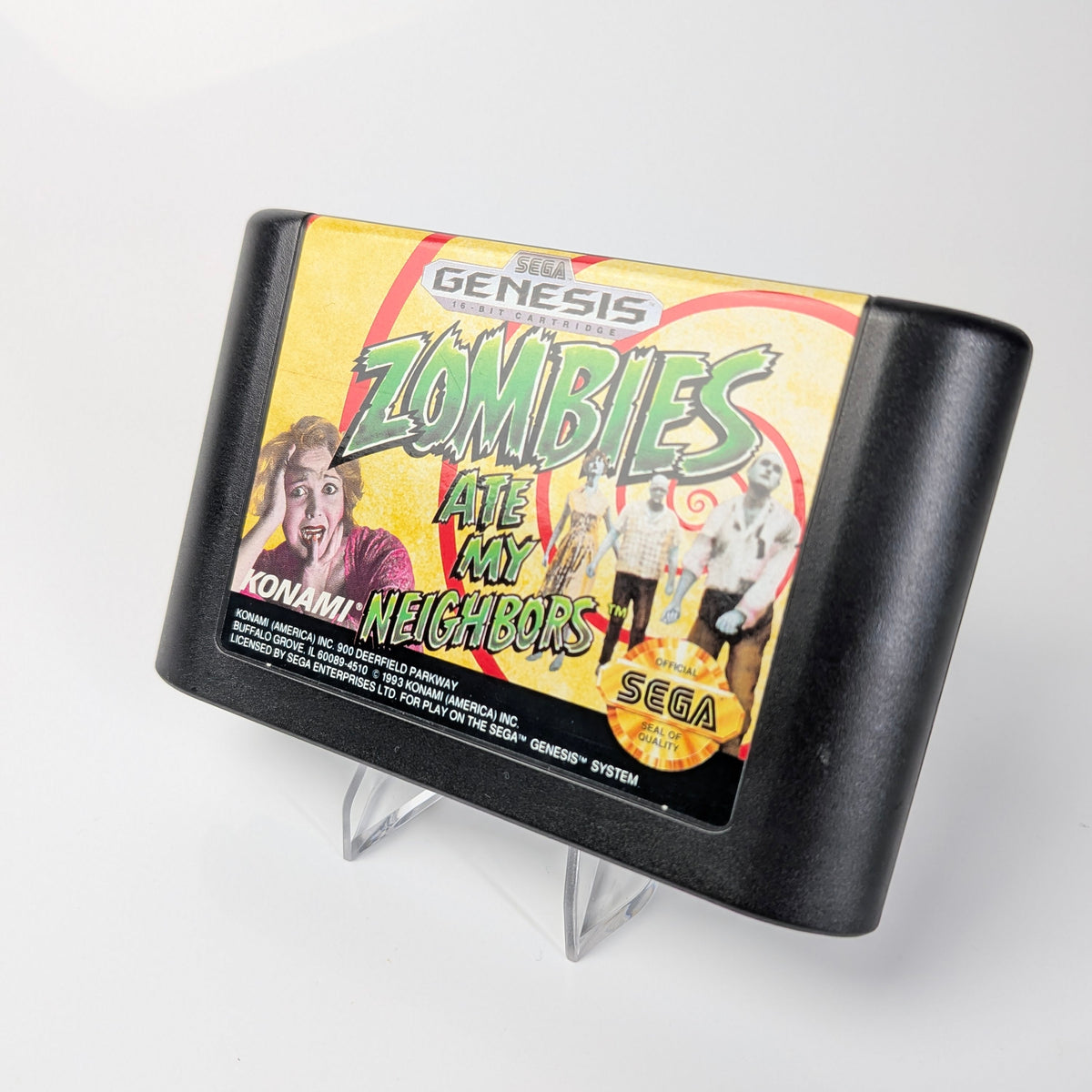 Sega Genesis game cartridge with 'Zombies Ate My Neighbors' on a white background