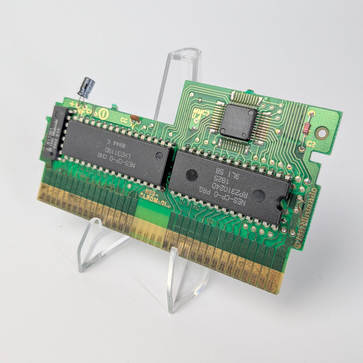 Two computer memory modules on a stand against a white background