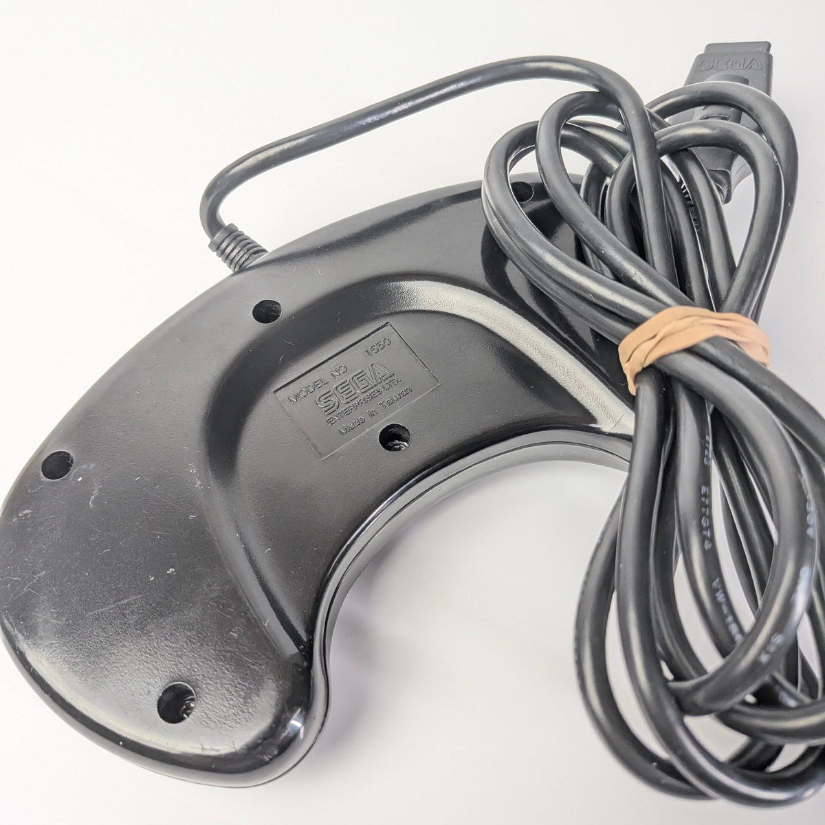 Metallic device with coiled cable on a white background