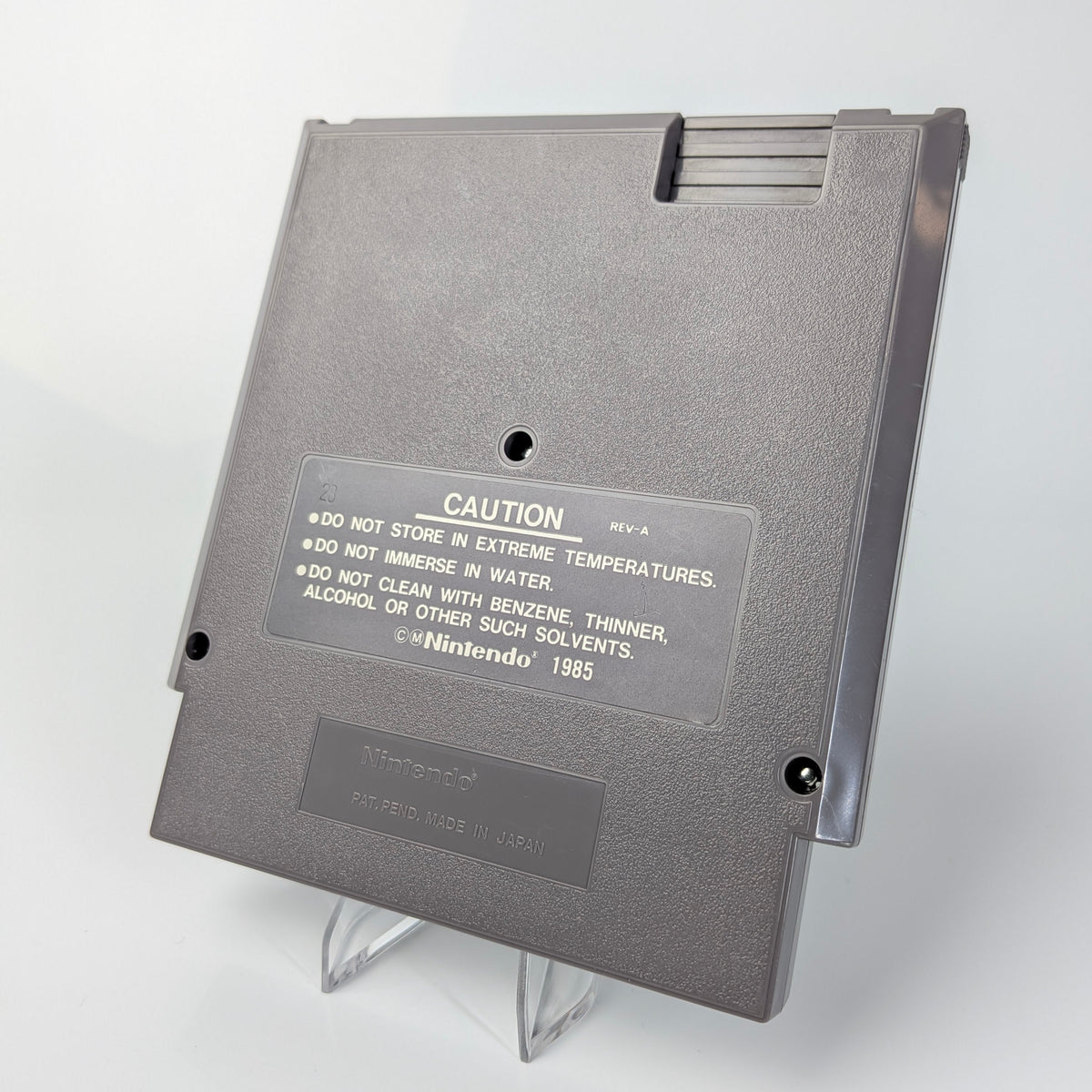 Gray cartridge with a caution label on a white background