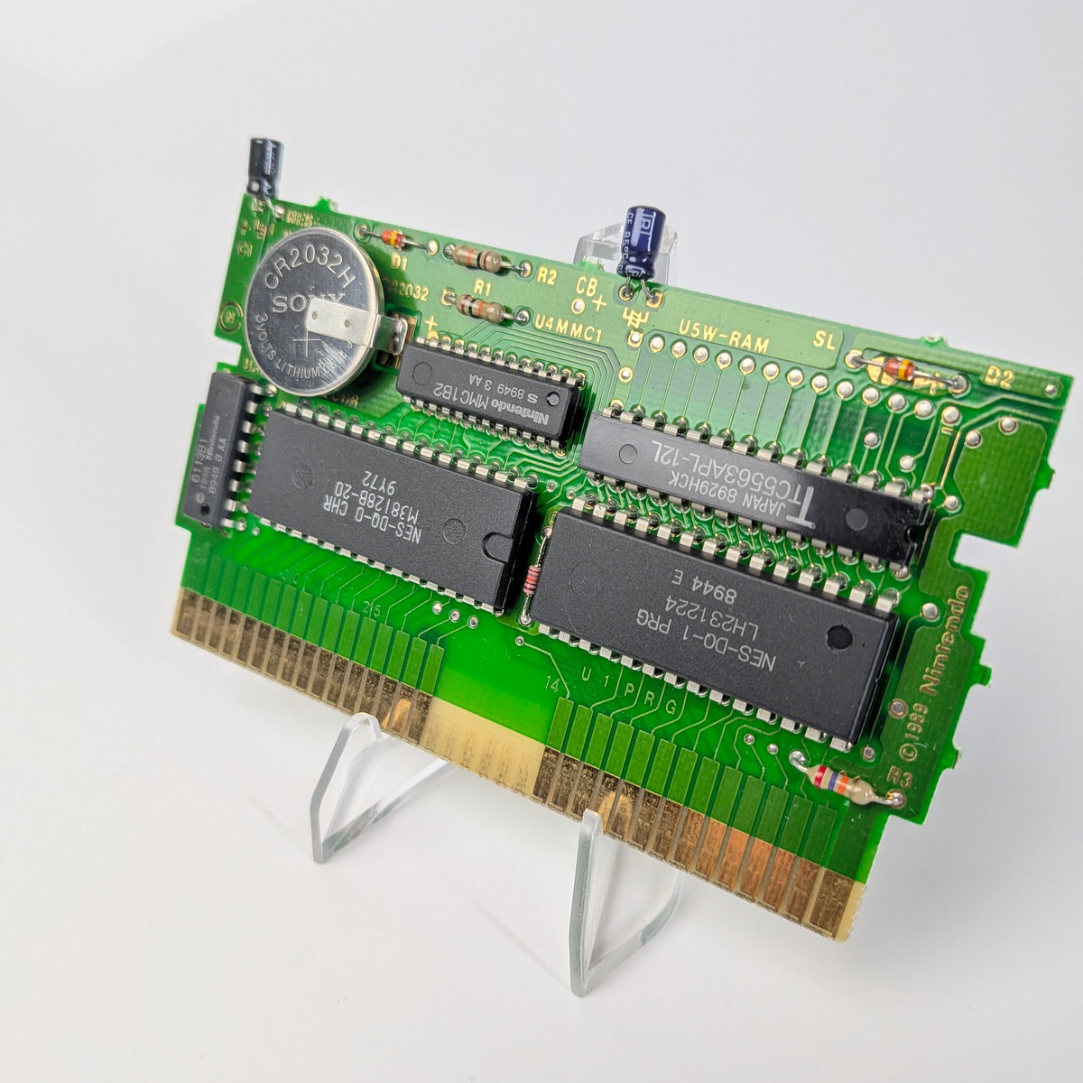 Computer memory card on a stand with a white background