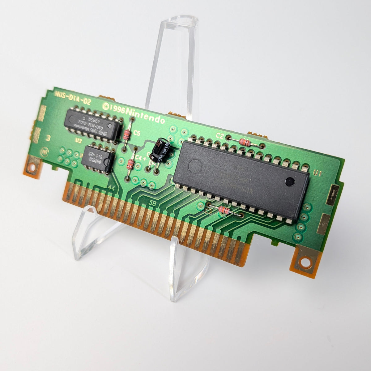 Green circuit board with electronic components on a white background