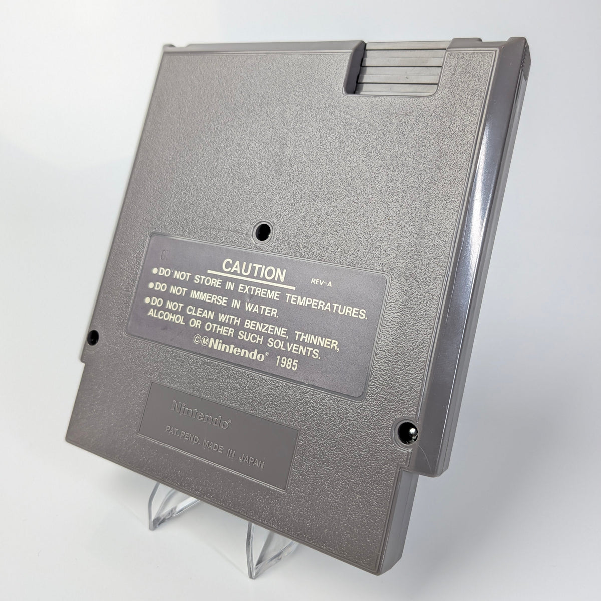 Gray floppy disk with warning label on a white background