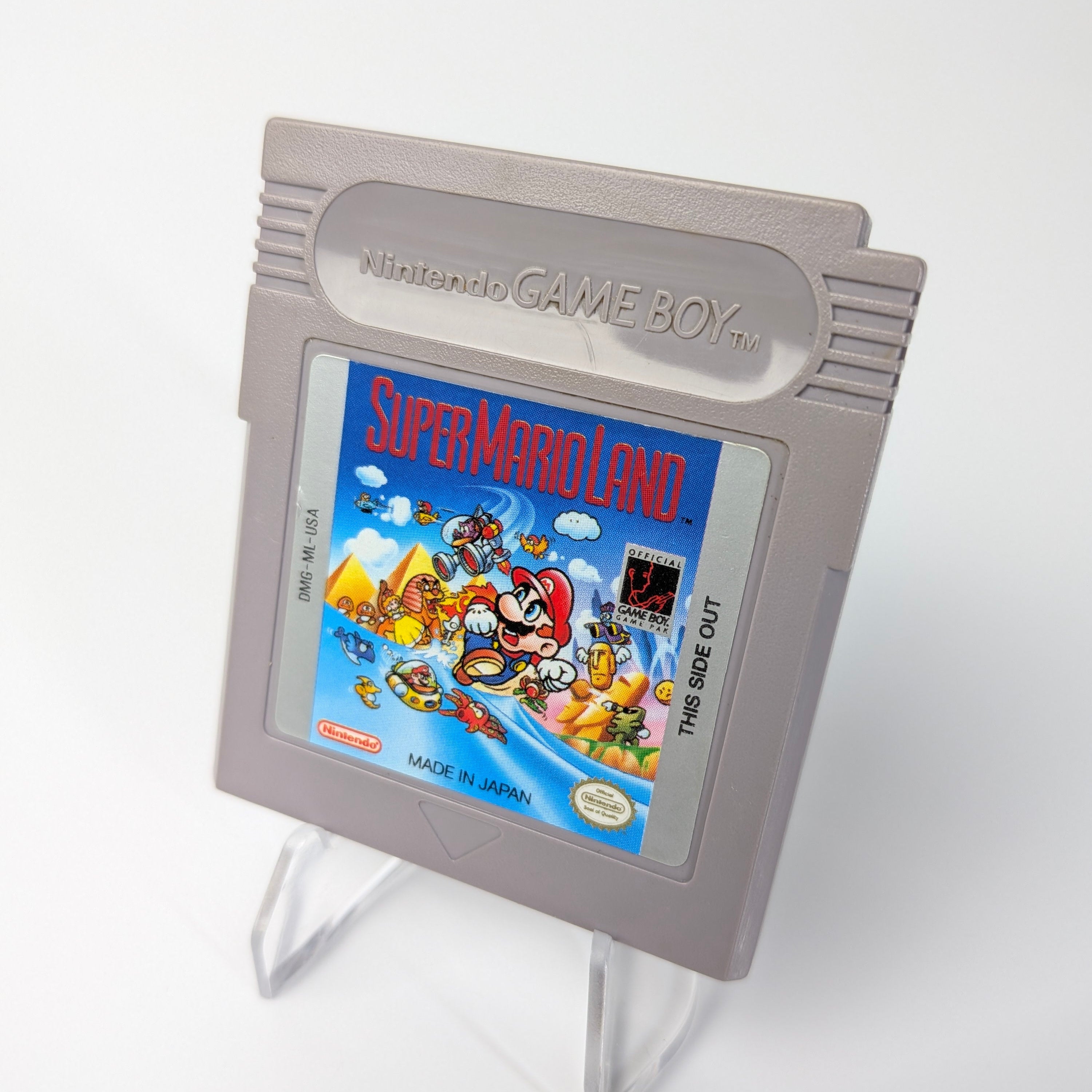 Nintendo Game Boy with Super Mario Land cartridge on a white background