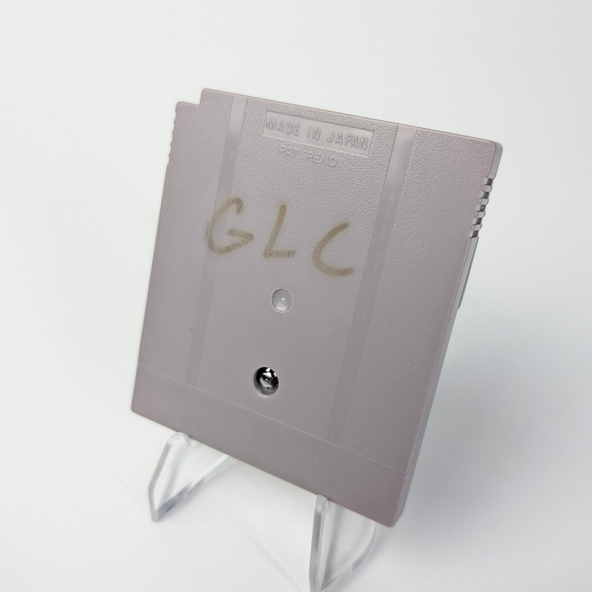 Gray electronic device with 'GLC' writing on a white background