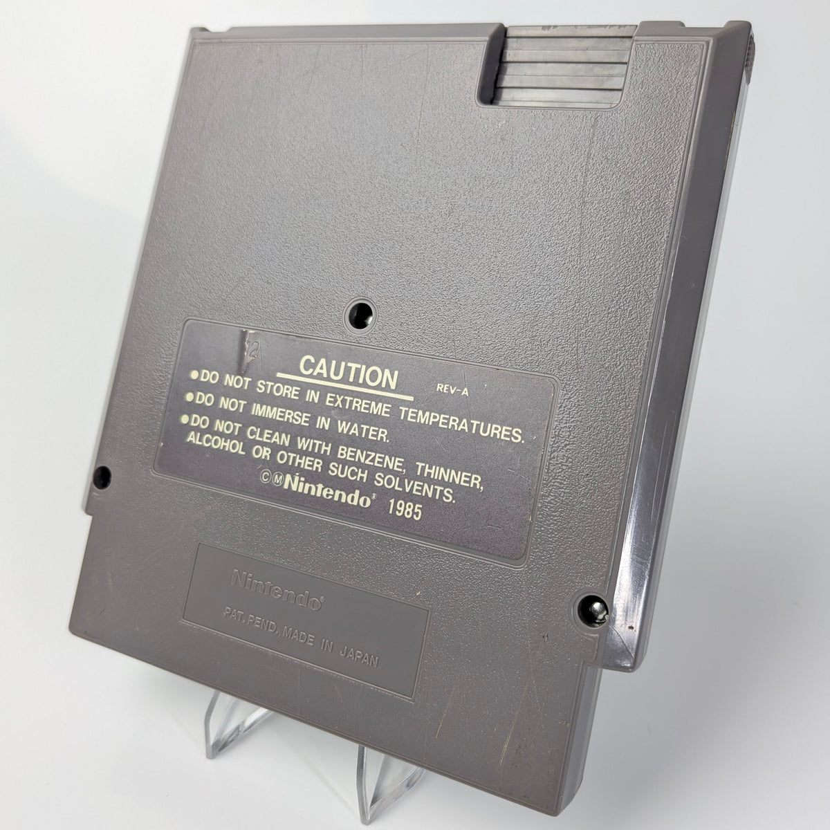 Gray floppy disk with caution label on a white background