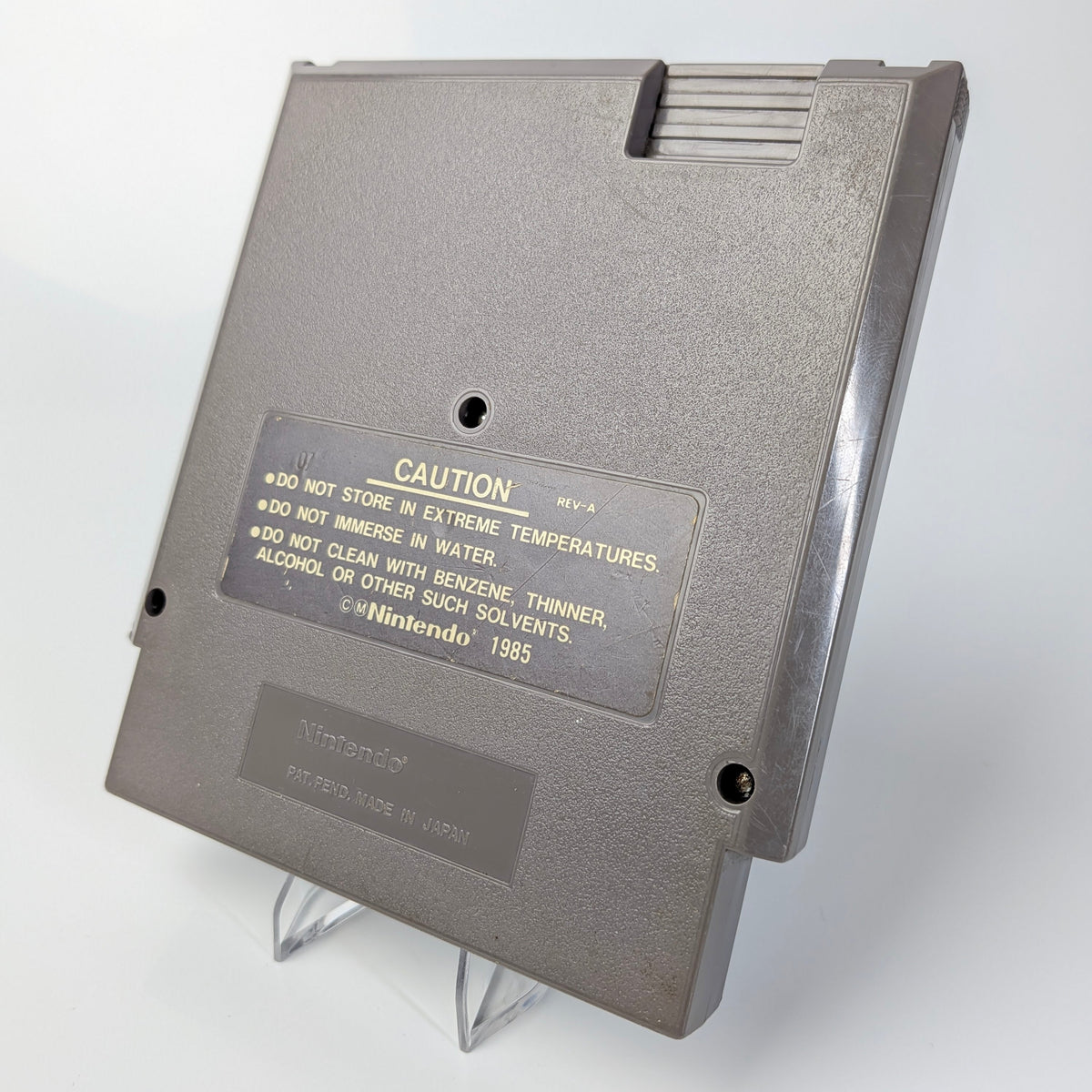Gray floppy disk with warning label on a white background
