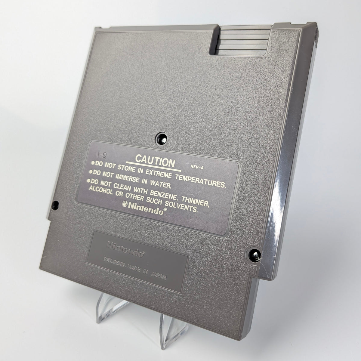 Gray floppy disk with caution label on a white background