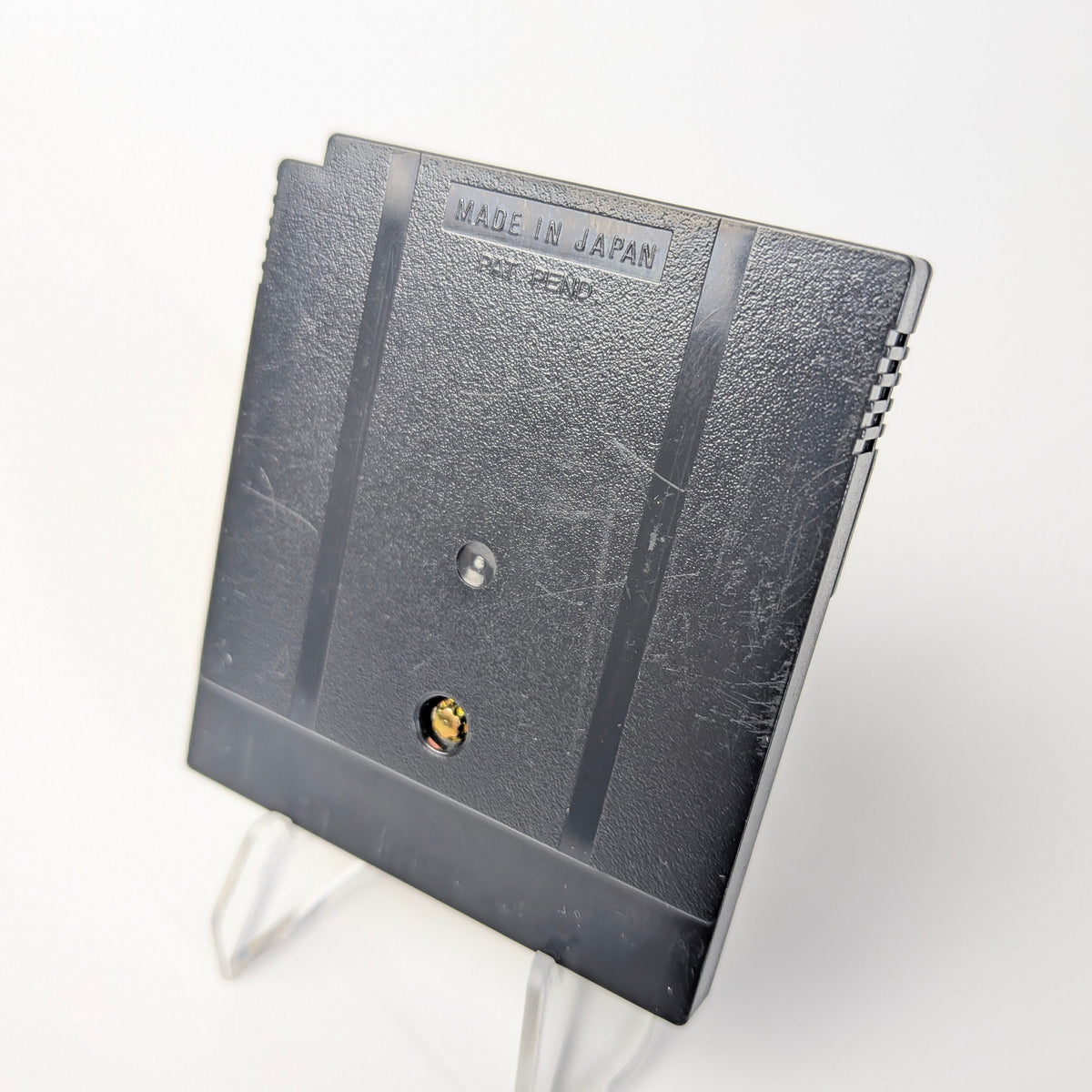 Small electronic device with 'Made in Japan' text on a white background