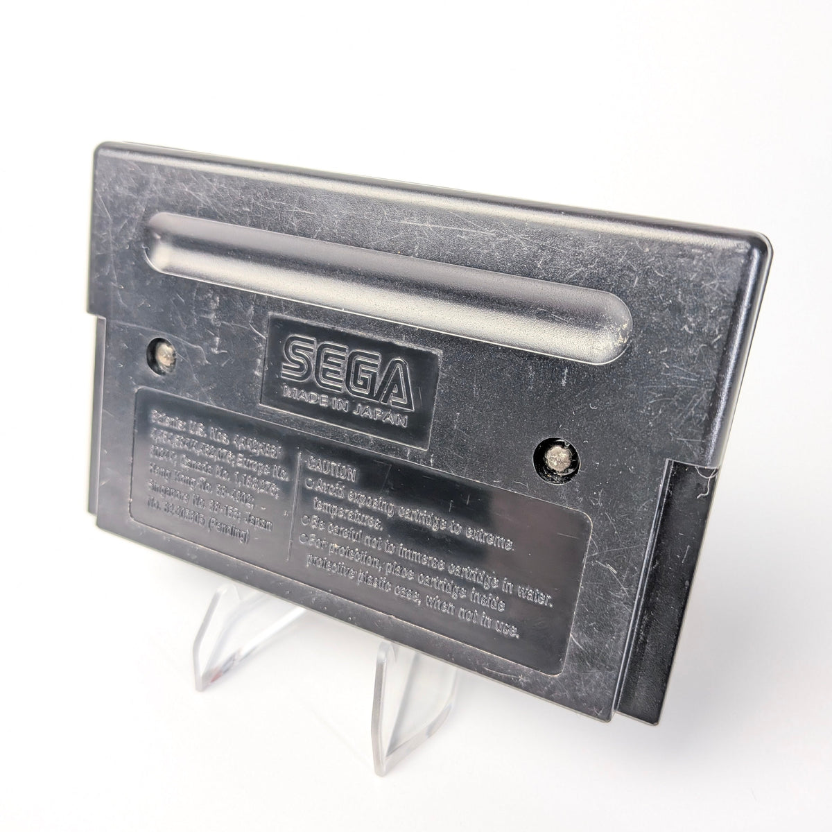 Sega cartridge on a stand with a white background