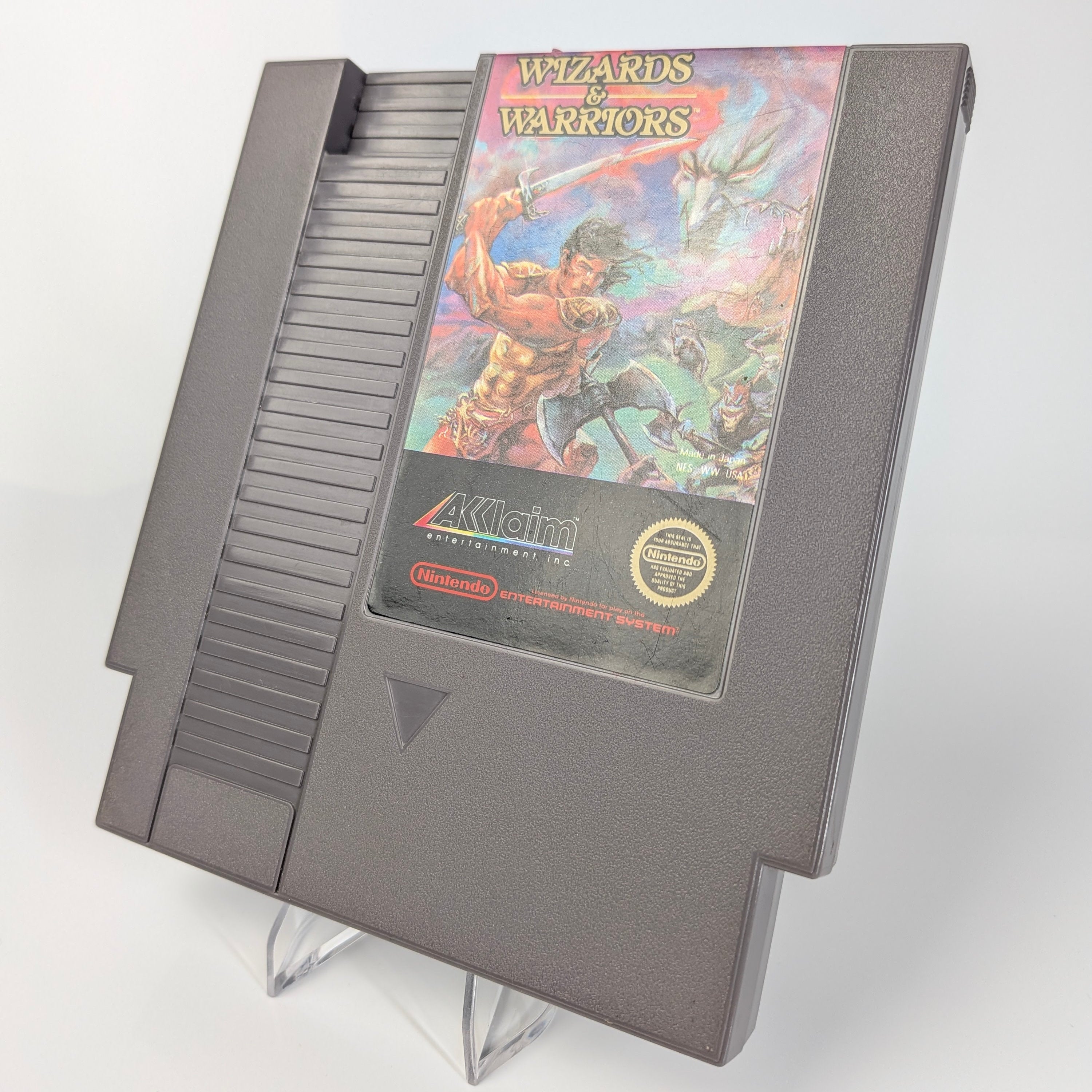 Nintendo Entertainment System game cartridge with 'Wizards & Warriors' artwork on a white background