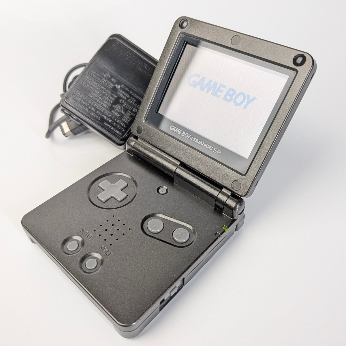 Gray Game Boy with screen displaying 'Game Boy' on a white background