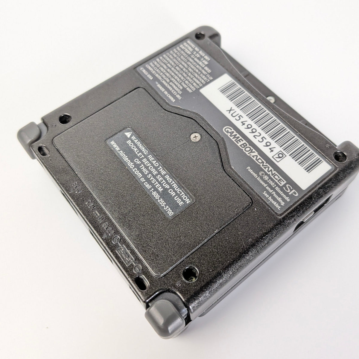 Black electronic device with barcode label on a white background