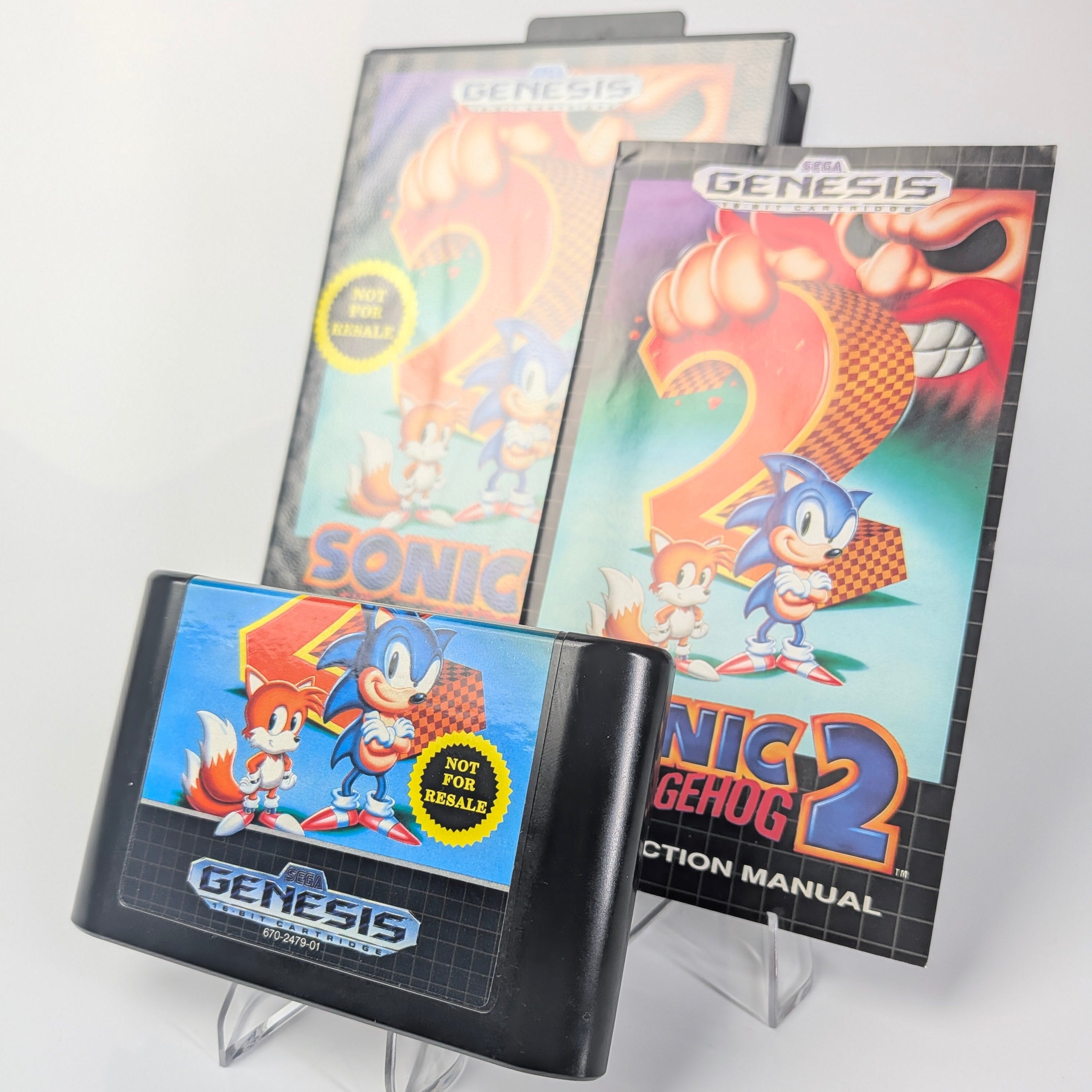 Sonic the Hedgehog 2 game cartridge and manual for Sega Genesis on a white background
