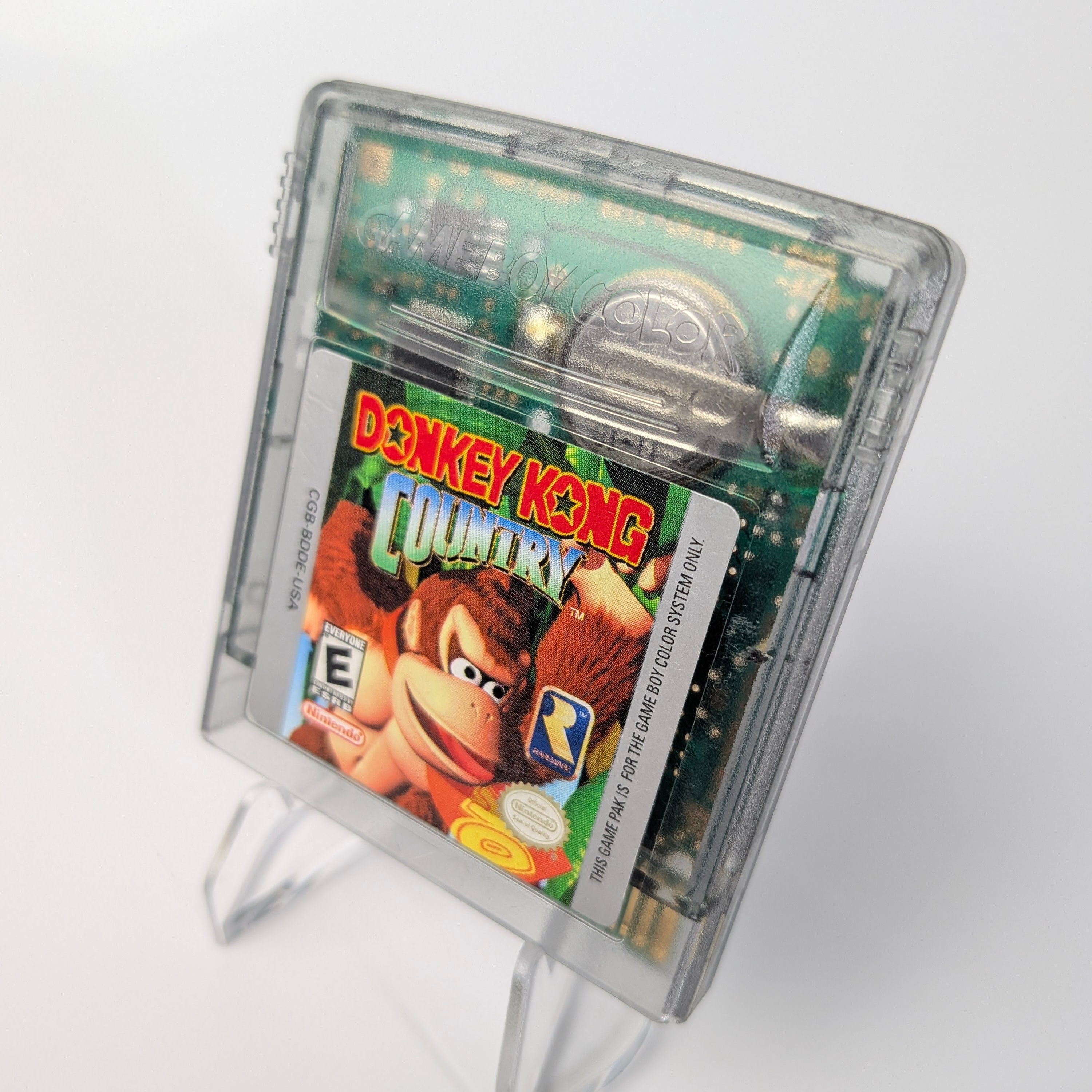 Donkey Kong Country game cartridge on a stand with a white background