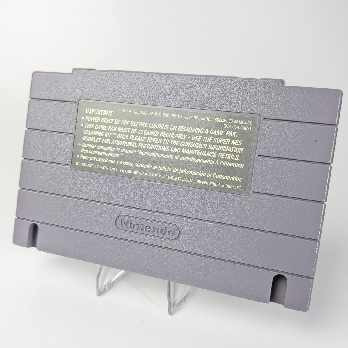 Gray Nintendo game cartridge on a white background