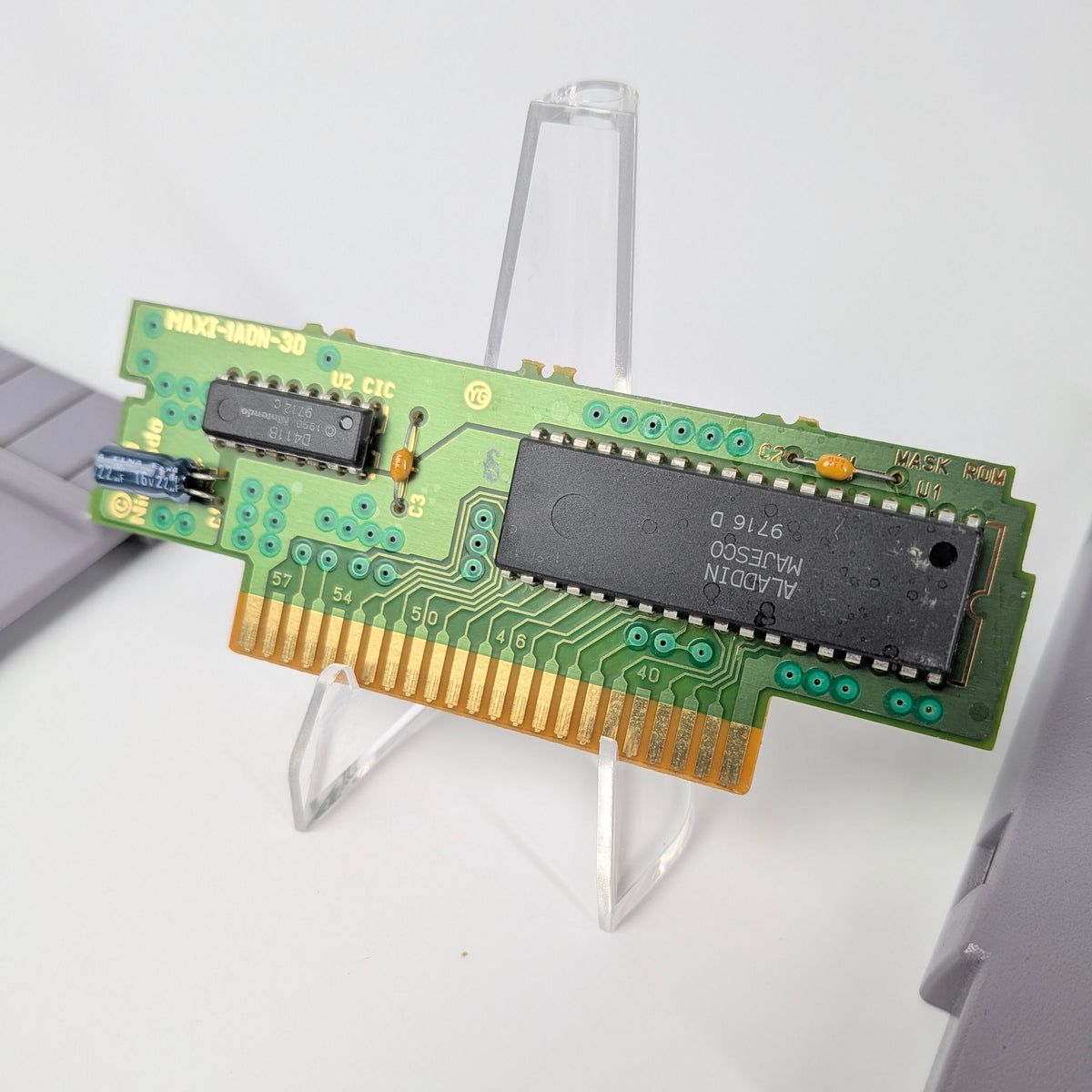 Computer memory module on a stand against a white background