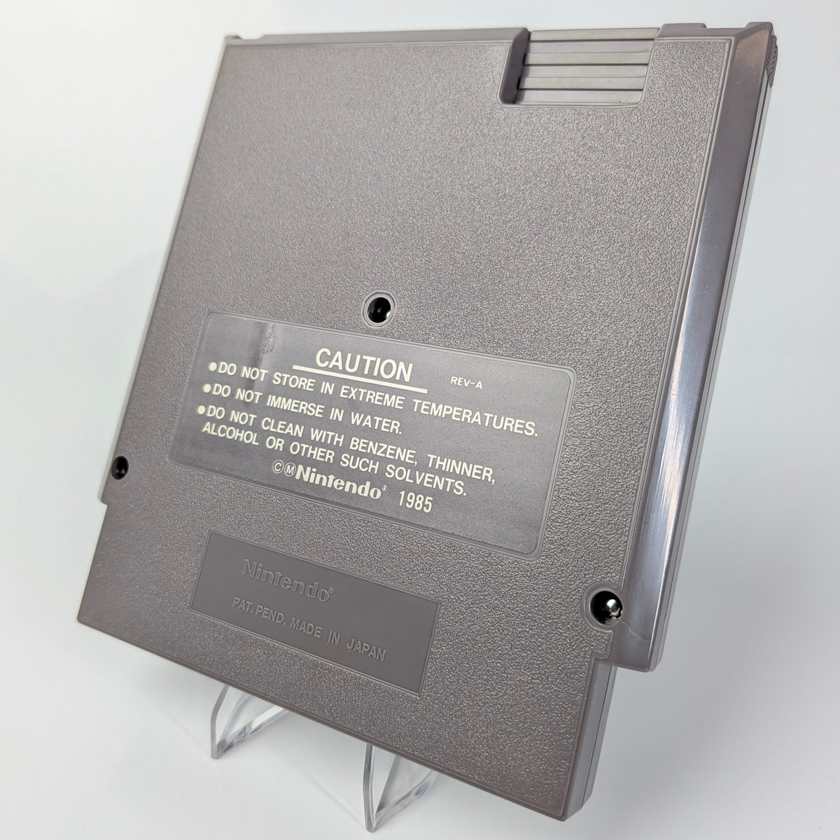 Gray cartridge with warning label on a white background