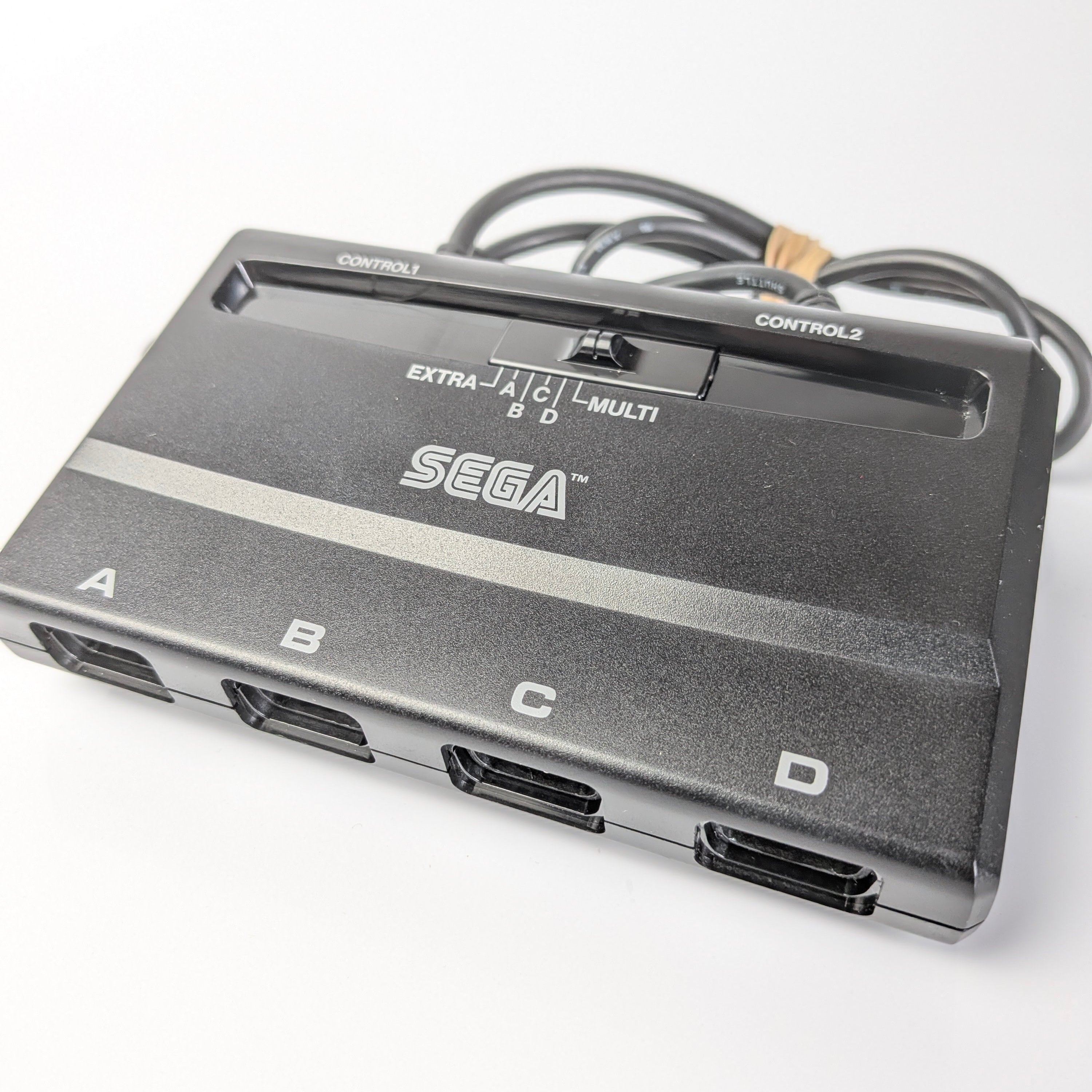 Sega multi-control adapter on a white background