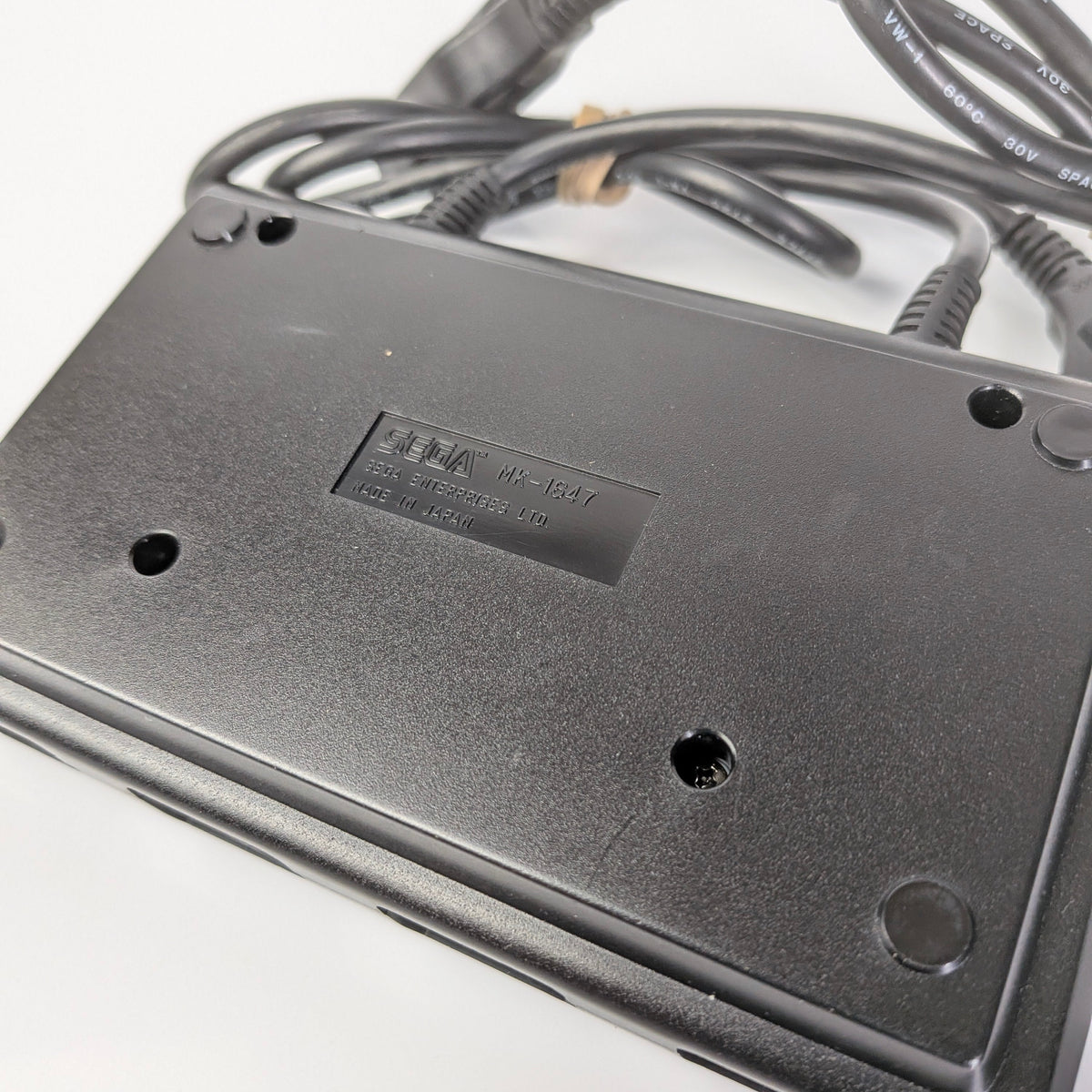Black electronic device with cables on a white background